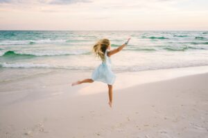 kid playing fun running at the beach