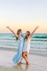 two happy friends at the beach