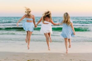 three girls running to the water